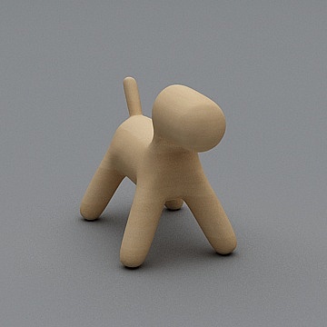 Minimalist light wood dog figurine with smooth matte finish on grey background