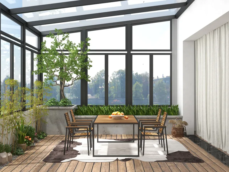 Bright sunroom featuring wooden dining table four chairs cowhide rug indoor plants and large windows