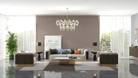 Modern living room with grey sofa gold coffee table crystal ceiling light and wall panel