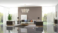 Spacious living room featuring beige sofa set marble floor plant crystal ceiling light and windows