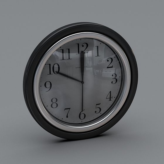Black round wall clock with silver trim and white face on grey background