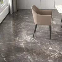 Dark marble floor with white veins and a modern brown leather chair in dining room