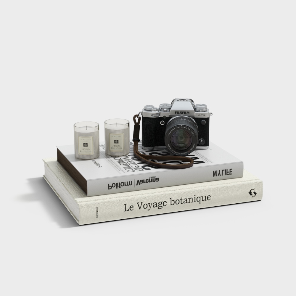 Silver camera and two candles on stacked books with white background