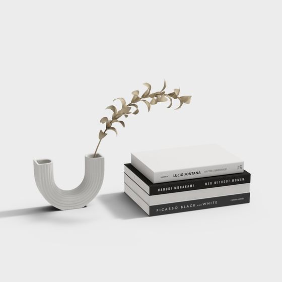 U-shaped white ribbed vase with beige plant and stacked books on grey background